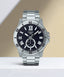 Casio MTP-VD200D-1B watch with a black sunray dial and a stainless steel link bracelet.