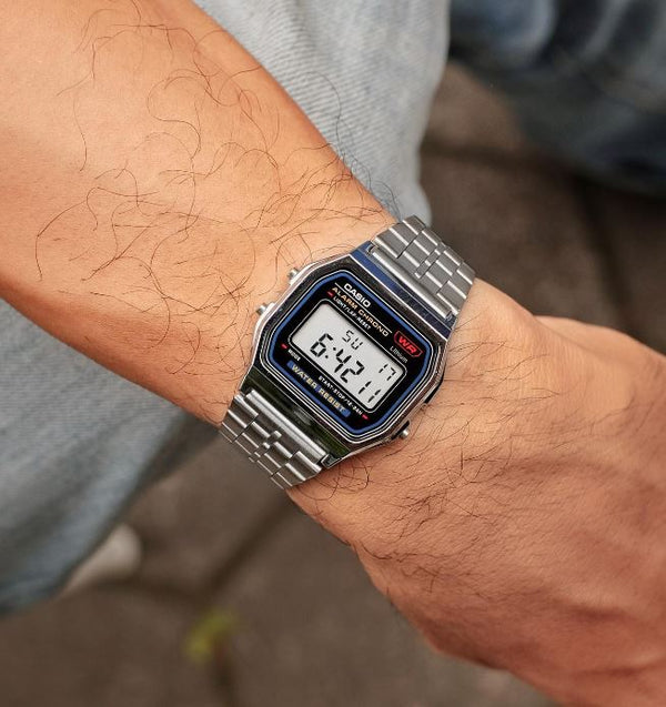 Casio A159W-N1DF watch with a classic rectangular digital display, chrome-plated resin case, and stainless steel band featuring a triple-fold clasp; includes LED light, daily alarm, stopwatch, and water resistance.