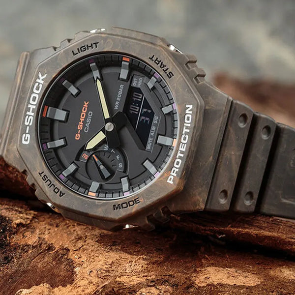 Casio G-Shock GA-2100FR-5A men's digital and analog watch with a rugged, camouflage-inspired design in brown and orange tones, featuring shock resistance,