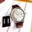 Citizen BI1054-04A men's analog watch with a white dial, silver-tone stainless steel case, brown leather strap, and date display at the 3 o'clock position. - Zamana.pk