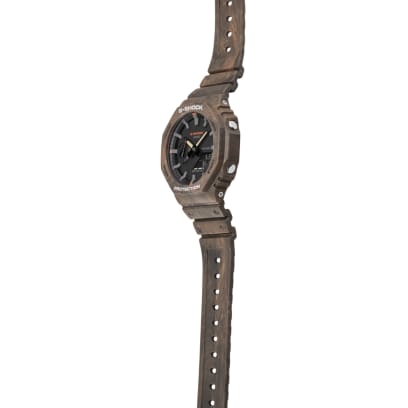 Casio G-Shock GA-2100FR-5A men's digital and analog watch with a rugged, camouflage-inspired design in brown and orange tones, featuring shock resistance