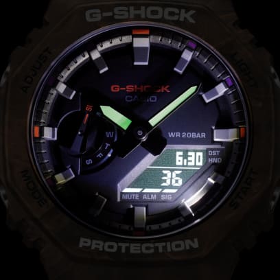 Casio G-Shock GA-2100FR-5A men's digital and analog watch with a rugged, camouflage-inspired design in brown and orange tones, featuring shock resistance