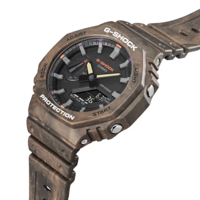Casio G-Shock GA-2100FR-5A men's digital and analog watch with a rugged, camouflage-inspired design in brown and orange tones, featuring shock resistance